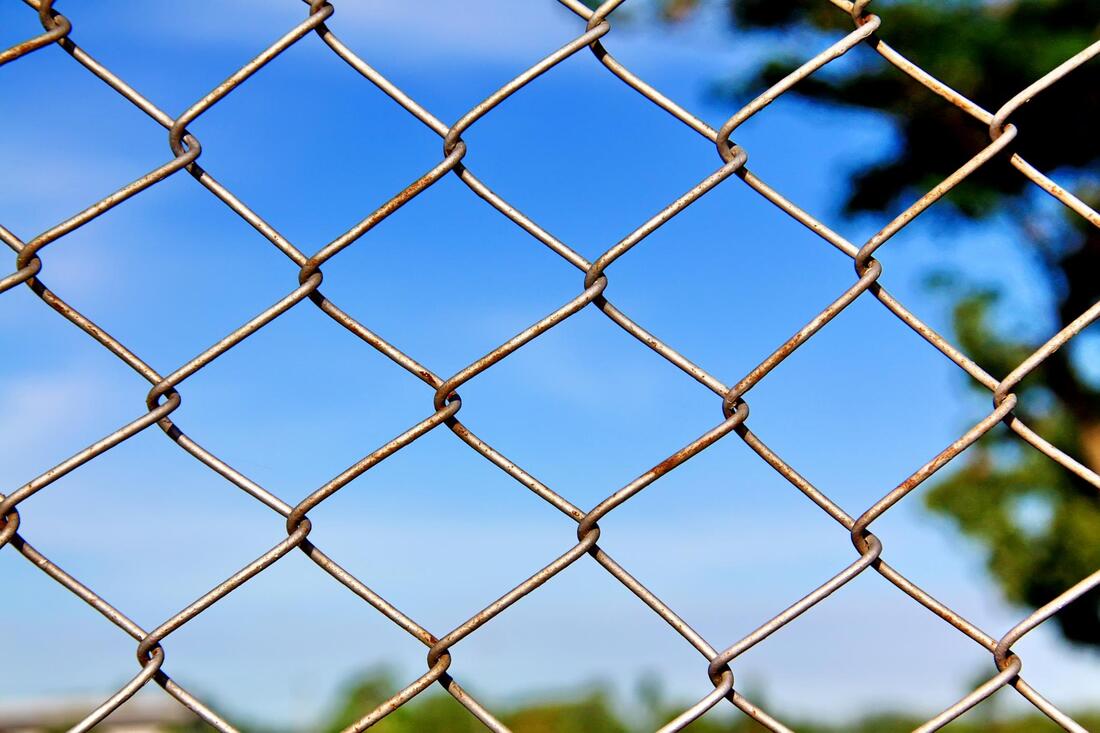 chainlink fence with a little rust on it